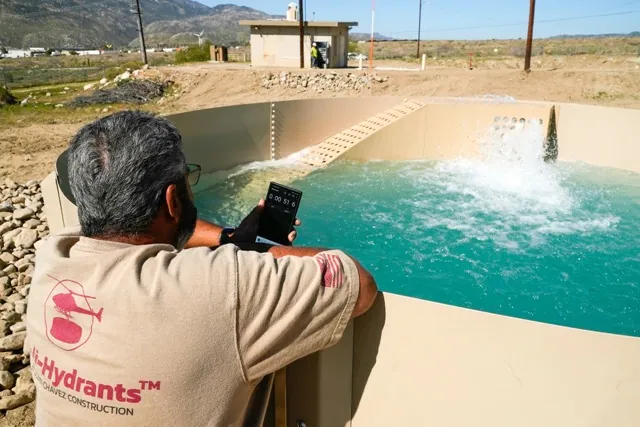Glenn Chavez sets a timer as water fills a newly installed Heli-Hydrant, a small, open tank that helicopters can rely on to get water faster for urban fires, Friday, April 11, 2025, in Cabazon, Calif.
Credit: Brittany Peterson AP Photo