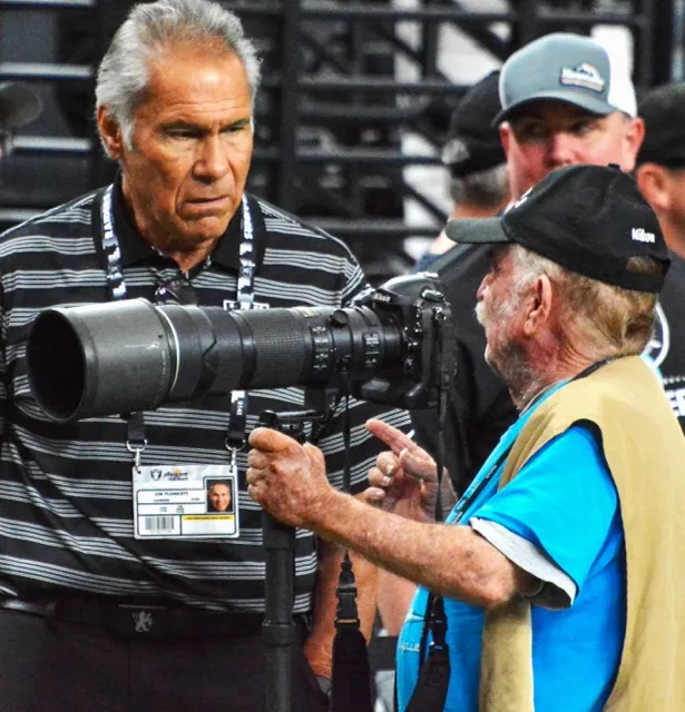 Jerry Soifer has the attention of former Stanford and Raiders great, quarterback Jim Plunkett, during the Raiders contest against the Green Bay Packers at Allegiant Stadium in Paradise, NV, on October 12, 2023. Credit: Gary Evans