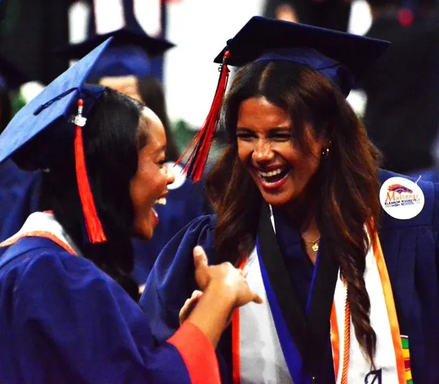 Sameyah Warren (left) and Leilani Woods (right) share a laugh during the Eastvale Roosevelt commencement ceremonies held at the Toyota Center in Ontario Wednesday morning. 1000 students graduated from the Class of 2025