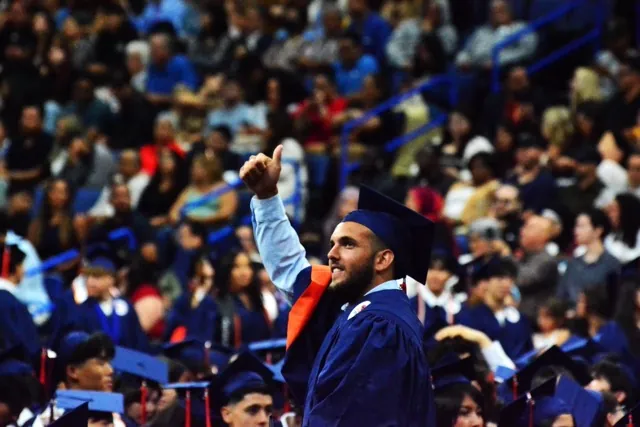 Eastvale Roosevelt Class of 2025 graduate Dario Salvia gives the thumbs up to family and friends Wednesday morning as part of 1000 students who took an hour and 45 minutes to be introduced at the Toyota Arena in Ontario.