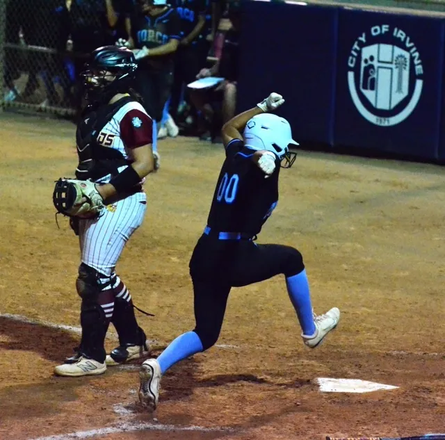 Norco’s Savannah Gonzalez (00) is about to put an emphatic YES on hitting home plate as the Cougars take a 2 – 0 lead over El Modena of Orange in the 5th inning of the CIF Division 1 Championship game. Vanguard catcher