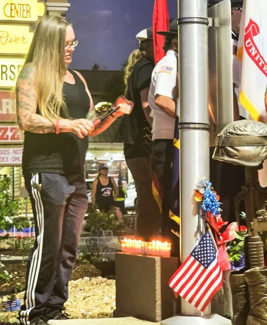 Shana Chappell lights a candle at the Fallen 13 Memorial Garden in Norco during a ceremony observing the fourth anniversary of the Abbey Gate Terrorist bombing that took the lives of 13 American servicemen and women, including her son, Kareem Nikoui.
Credit: Photo by Gary Evans
