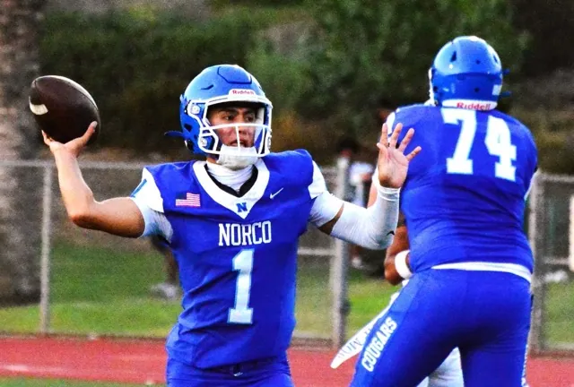 Norco’s Linebacker Henderson Carter made an incredible twisting interception of a Cajon pass, and raced 60 yards for a touchdown.  Intended receiver Landon White (1) pursues. 