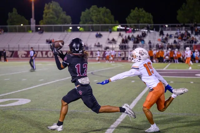 Paloma Valley’s Noah Davis (13) catches a break away pass, beating Orange Vista’s Rami Babino (19), and goes 69 yards for a TD