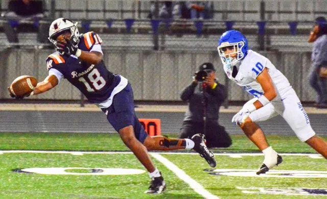 Eastvale Roosevelt’s Yankee Guitierrez (18) makes an incredible catch in front of Norco’s Manuel Hernandez (10) late in the game. The Cougars defeated the Mustangs 50 – 14.