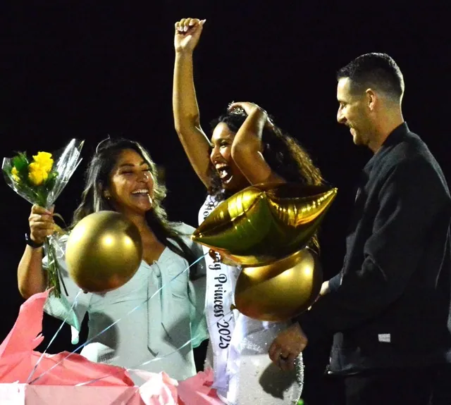 Norco High’s Toni Backus (center) and her parents celebrate as she is announced Homecoming Queen for 2025.