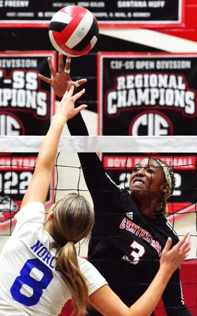 Norco’s Kayden Koning (8) and Corona Centennial’s Jordyn Wilson (3) battle for the ball above the net. The Huskies defeated the Cougars 3 – 0.