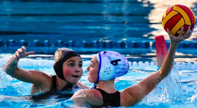 Corona Santiago’s Riley Romero (11) eyes the ball while Los Alamitos Hailey Rippeon (6) looks to pass during the first round CIF playoff match. The Sharks held off the Griffins 10 – 8.