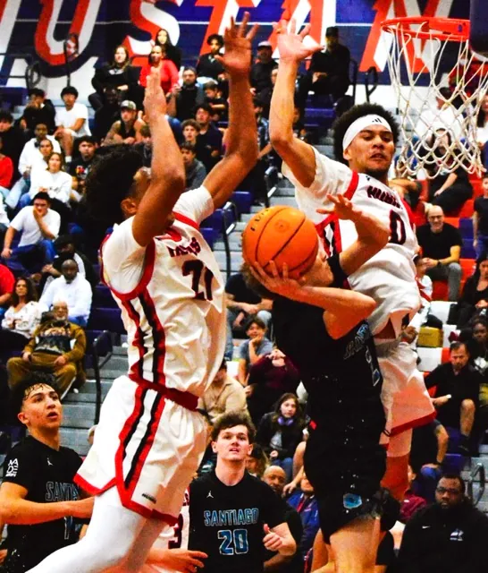 Corona Centennial’s Isaiah Rogers (21) and Kai Patton (0) get ready to lower the boom on Santiago’s Evan Nayback (2). Rogers blocked and controlled the ball. Tied at halftime at 28, the Huskies dominated the 2nd half, winning 59 to 38.