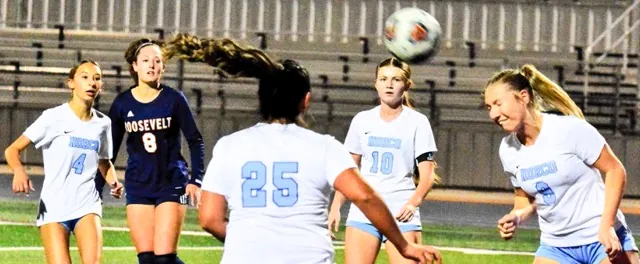 Eastvale Roosevelt’s Emma Gause (8) and Norco’s Peyton Maxon (4), Ella Moreno (25), and Camryn Wagner (10) watch Briana Sousa (9) head the ball out of the goal crease during the Mustangs 2 – 0 win over the Cougars.