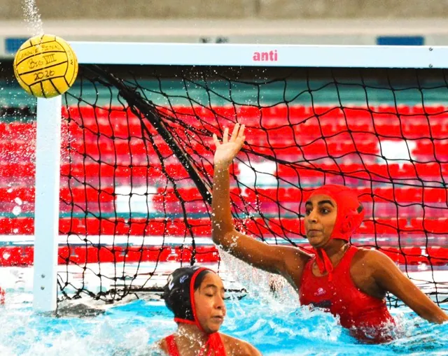 Centennial’s Elena De Gante (2) has goalie Shaili Patel (1) block an Aliso Niguel shot behind her. The Huskies defeated the Wolverines 19 – 4.