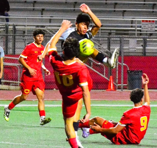 Corona’s Julian Sanchez (left) watches teammate Rooney Rodriguez (10) and Centennial’s Andres Araiza (top) fight for the ball while Julian Sanchez (9) calls for a foul during the Panthers’ 1 – 0 victory over the Huskies.