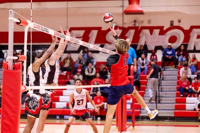 A last ditch attempt to float the volleyball over the net comes up short