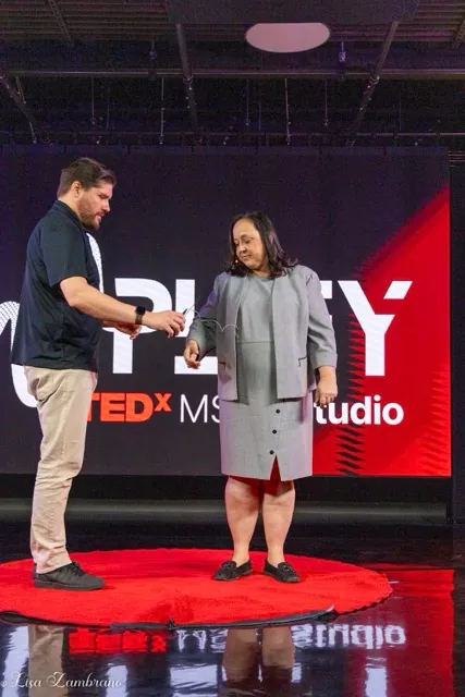 Dr. Jennifer Root, Menifee Union School District Superintendent, is mic’d up by Alan Marsala, Associate Professor & Chair of the Creative Media Department at Mt. San Jacinto College, before she gives a TED talk about the importance of understanding the underlying reason for student truancy, at the MSJC Studio in Menifee.