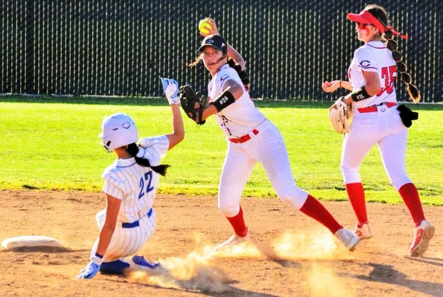After completing the force at 2nd before Norco’s Sadie Burroughs (22) slid in, Centennial shortstop Teuuaina Sanchez completes the double-play with her throw to 1st. But the Cougars prevailed 14-0.