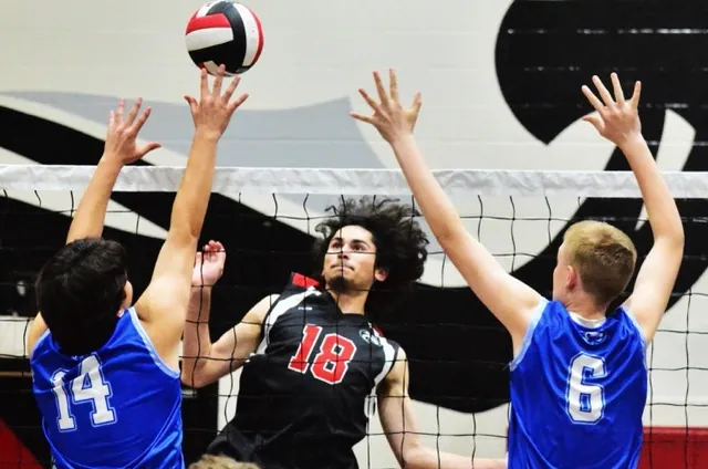 Norco’s Marco Mastache (14) and Nathan Roy (6) can’t stop Corona Centennial’s Daniel Navarro Jr. (18) dink over the net.
