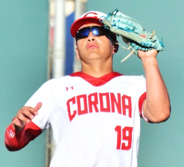 The bright sun reflects off the sunglasses of in Corona right fielder Danny De La Torre’s after he made the catch on a high pop fly against Riverside King.