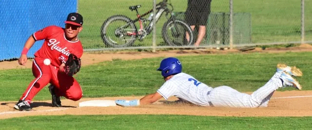 Centennial 3rd Baseman Bobby Anderson awaits the throw from catcher Michael Nonis as Norco’s Zion Martinez (24) slides safely into third. The Cougars defeated the Huskies 8 – 4.