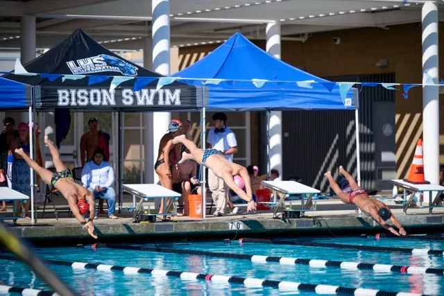 Swimmers explode off the blocks to begin a heat during Wednesday’s meet at Liberty High School.