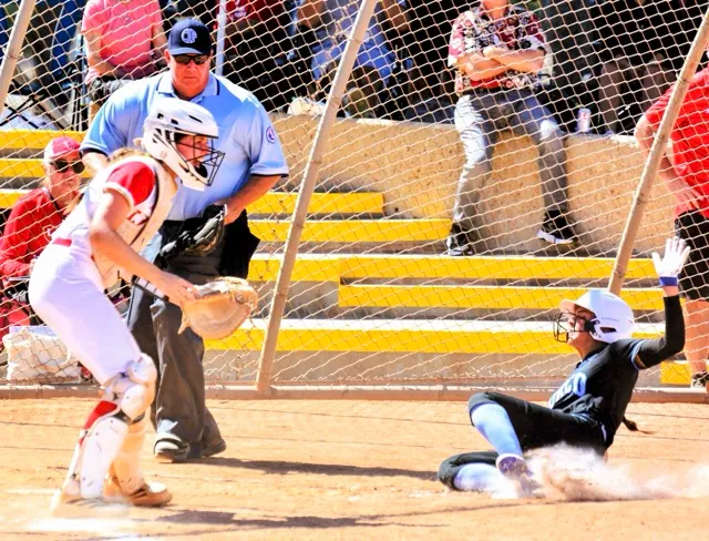 Norco’s Rae Logue (right) slides into home with a run during the Cougars 2 – 0 victory over Orange Lutheran.