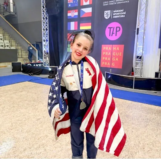 MUSD 8th Grader. Harlie Granger beams with pride draped in American regalia. Credit: MUSD