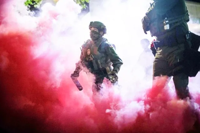 Masks for Federal Agents. AP Photo/Ethan Swope