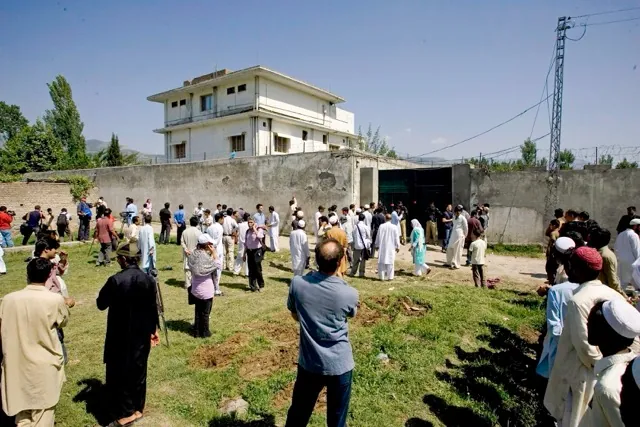 May 1. In this May 3, 2011, file photo local people and media gather outside the perimeter wall and sealed gate of the compound and house, top left, where al-Qaida leader Osama bin Laden was caught and killed in Abbottabad, Pakistan. The hunt for Osama bin Laden took nearly a decade. Bin Laden, who was the mastermind behind the September 11, 2001 attacks on the World Trade Center in New York City, and Pentagon in Arlington, Virgina, was killed by an elite team of Navy SEALs on May 2, 2011.  Credit: AP Photo/Anjum Naveed,