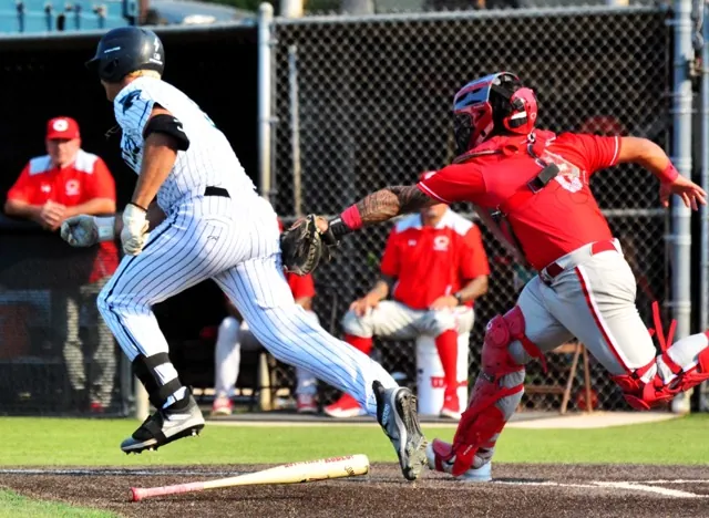 Corona Santiago’s Max Eldridge (left) is tagged out by Corona catcher Jesiah Andrade (right) after a dropped third strike. The Panthers advanced 6–1, eliminating the Sharks in the D1 double-elimination tourney. The Panthers travel to Sherman Oaks today (Friday) to play Notre Dame. The Knights shut out Norco 4-0 in the second round. After topping Ayala in the third round, the Cougars are at Orange Lutheran today.