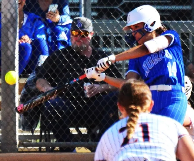 Norco’s Leighton Gray blasts a two-run homer as Mustang third baseman Cali Stewart looks in.