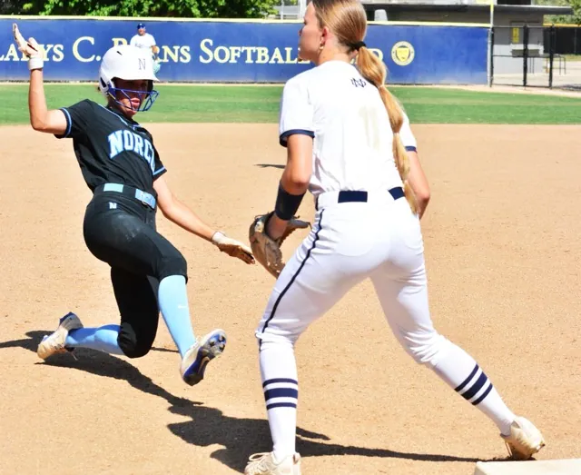 Norco’s Leighton Gray slides into third base while Kelsey Luderer of Notre Dame Sherman Oaks waits for the throw. The Cougars routed the Knights 8 – 0 in the quarter-final game.