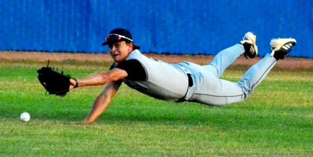 Santiago centerfielder Max Eldridge makes a diving try for a shallow line drive to center against Norco. The Cougars swept the three-game series from the Sharks.