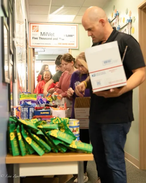 Volunteers lined up around MilVet to collect food and other snacks. Hilden encouraged volunteers to add in a few other items they thought the soldier may enjoy. Credit: Lisa Zambrano