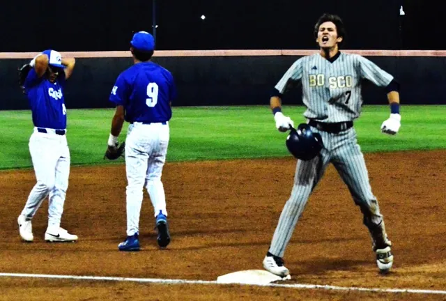 St. John Bosco’s Jack Champlin celebrates at third after he tripled off the left field wall, scoring a run while Norco’s Austin Maltese (left) and Jayden Serna (9) react.   