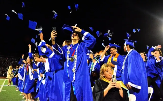  Norco High students, teacher and Mayor Robin Grundmeyer (lower middle) record the festivities as they toss their caps in the air at the end of the 2026 Graduation ceremony Wednesday evening. Additional photo on P16. Photo by Gary Evans