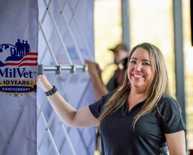 MilVet CEO Raven Hilden smiles as she helps set up for the massive military care package event at Storm Stadium.