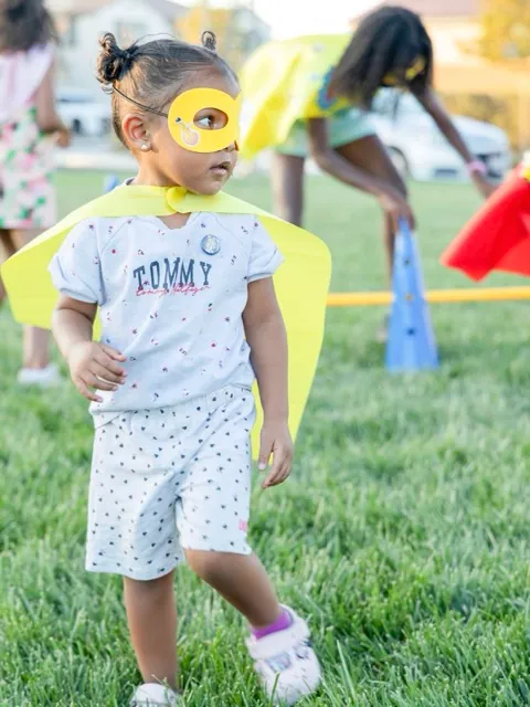 RIGHT: Berline, 3, dressed like a super hero. A supper hero booth, and obstacle course, were set up so kids could live out their superhero dreams.