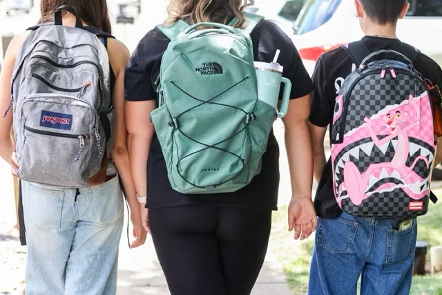 Backpack Overload. Middle school students Claire Knoth and Brockton Lozano and high school student Zoie Knoth walk with their backpacks Friday, July 31, 2026, in Flagstaff, Ariz. Credit: AP Photo/Cheyanne Mumphrey