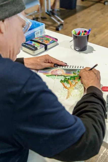 Ernest Carreon draws a dreamy nature scene during the Crafting Corner at the Menifee Library, Saturday August 8. Credit: Photo by Lisa Zambrano