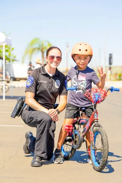 Officer Megan Antonissen & 6 year old Ethan take a photo together. Ethan was very excited to attend, asking his dad, Carlos, “can you take me to this bike safety event, please!"