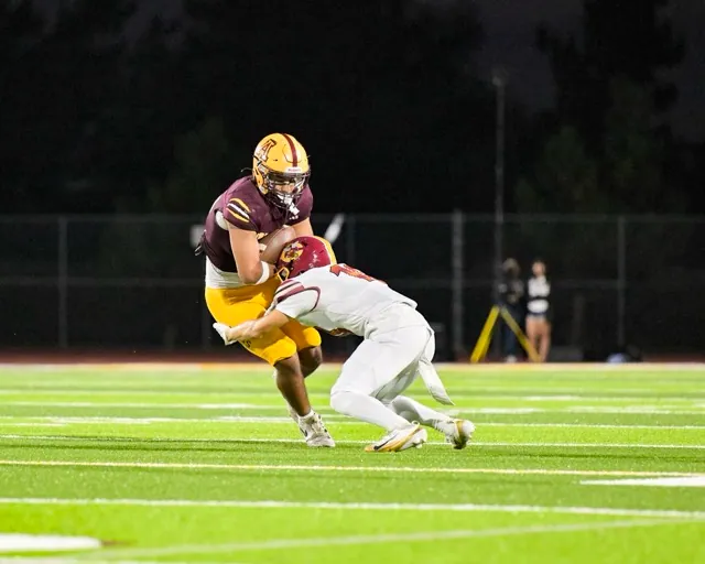 A Colton Defender wraps up Arlington’s running back in the open field
