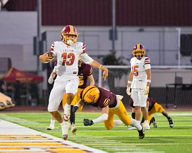Colton Quarterback Koa Regalado #13, scrambles outside the box for a 10-yard gain, hurdling over an Arlington defender. 