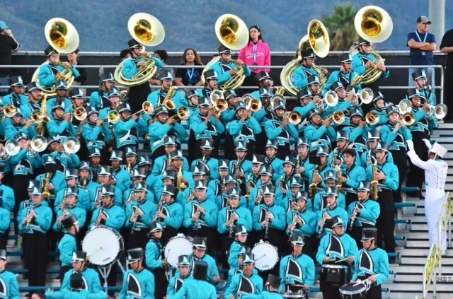 Santiago’s band lights up the stadium in their bright teals while entertaining the crowd at the Silverado-Sharks football game.