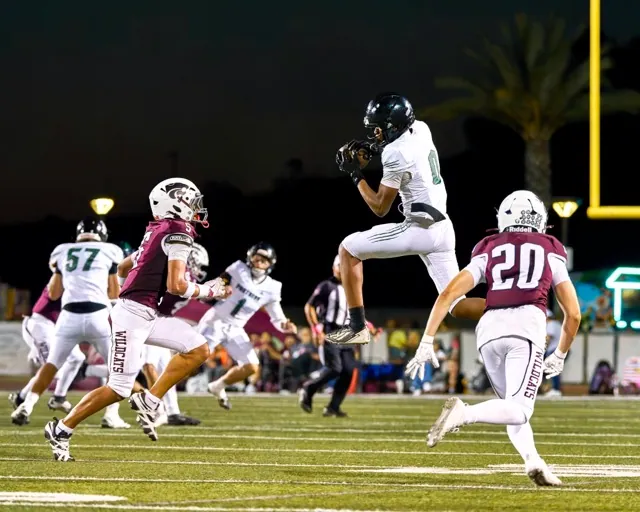Perris’s Jordan Johnson (#0) secures a pass as Paloma Valley’s Antonio Castellon (#20) sizes up the tackle